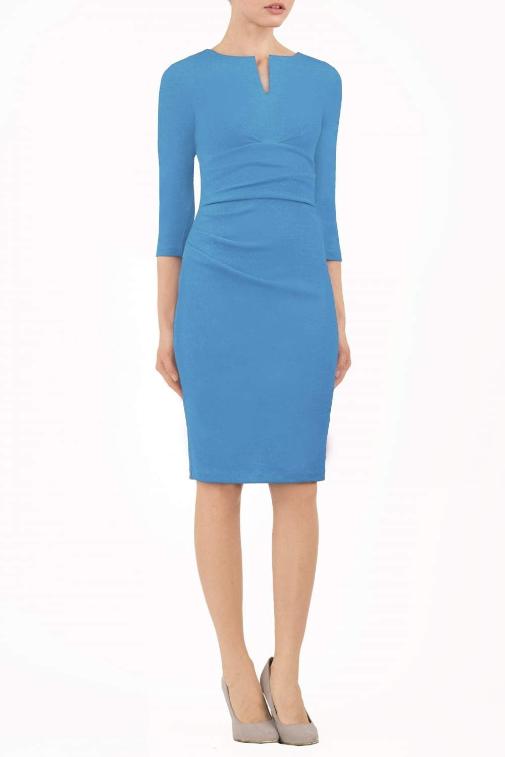 model wearing diva catwalk donna pencil dress in colour malibu blue with wide band and sleeves and rounded neckline with low split in front