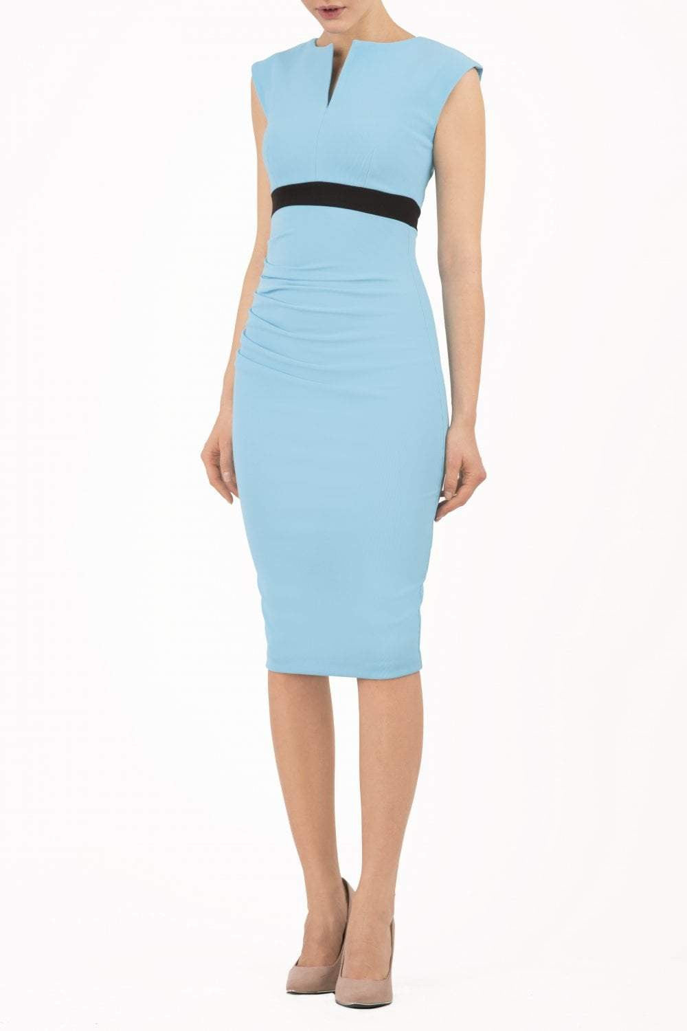brunette model wearing diva catwalk nadia sleeveless pencil dress in sky blue colour with a contrasting black band and exposed zip at the back with a rounded neckline with a slit  in the middle front