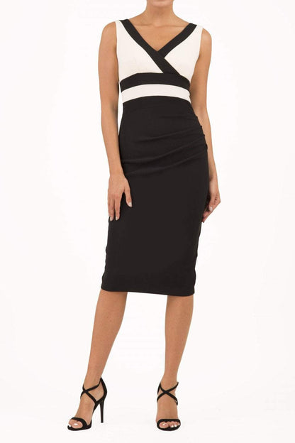 model is wearing duva catwalk banbury sleeveless colour block pencil dress with low v-neck in black and ivory front