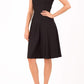 Brunette Model is wearing a sleeveless swing high neck dress in black by Diva Catwalk front