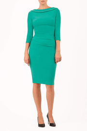model wearing diva catwalk york pencil-skirt dress with sleeves and rounded folded collar and plearing across the tummy area in emerald green colour front
