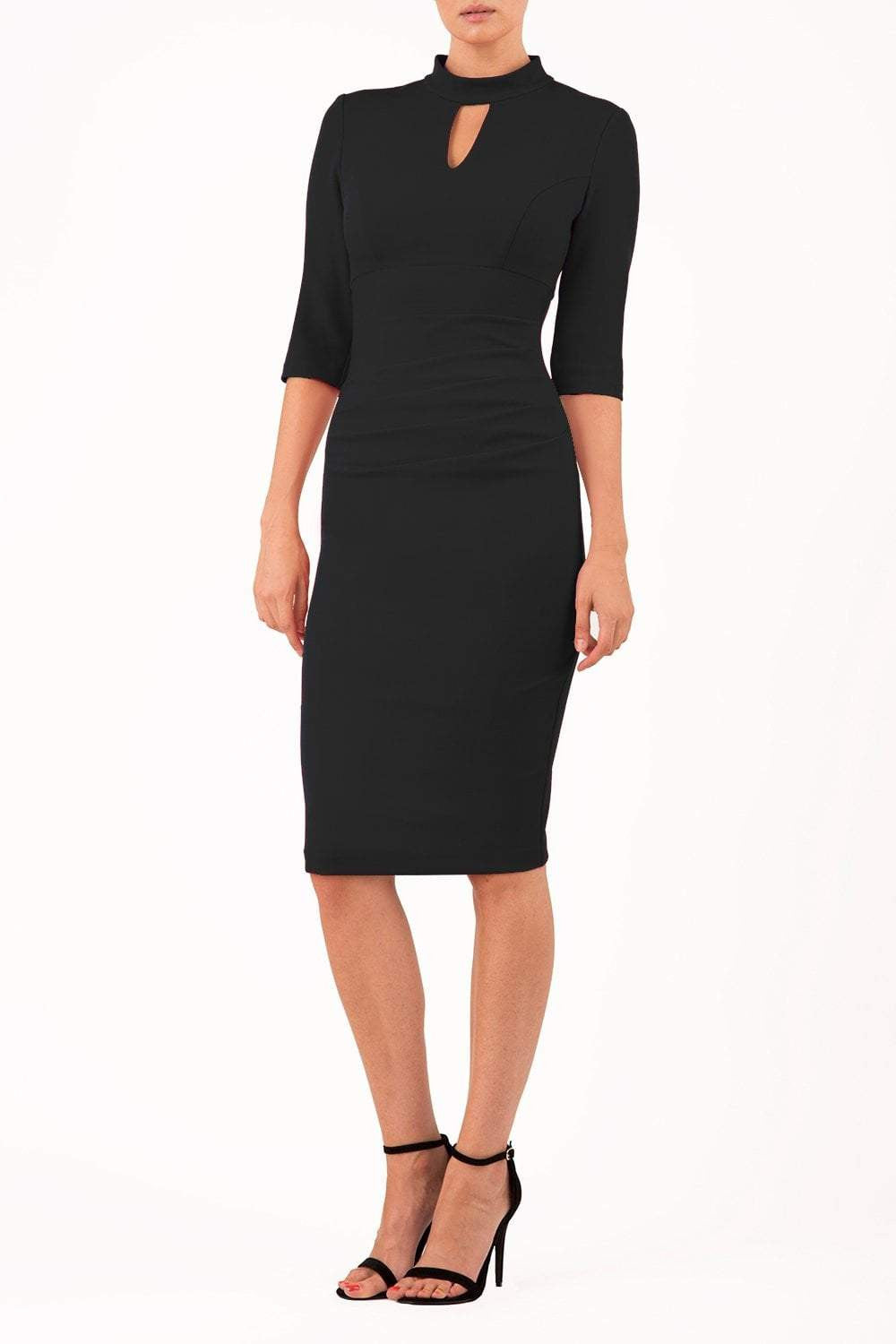 model is wearing diva catwalk pinhoe pencil dress with sleeved and high neckline with a keyhole detail in the middle and pleating across the tummy area in black front