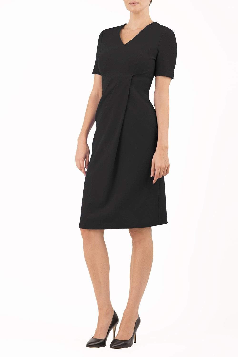 brunette model wearing diva catwalk tregony a-line dress with lowered v-neckline in black and short sleeves front