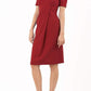brunette model wearing diva catwalk tregony a-line dress with lowered v-neckline in passion red and short sleeves front