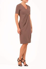 brunette model wearing diva catwalk tregony a-line dress with lowered v-neckline in brown and short sleeves front