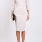 Model wearing the Seed Agatha in pencil dress design in sandy cream back image