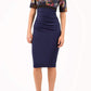 model wearing diva catwalk nadia fitted pencil dress made in the uk with short sleeves and pleated pencil skirt in navy and black front