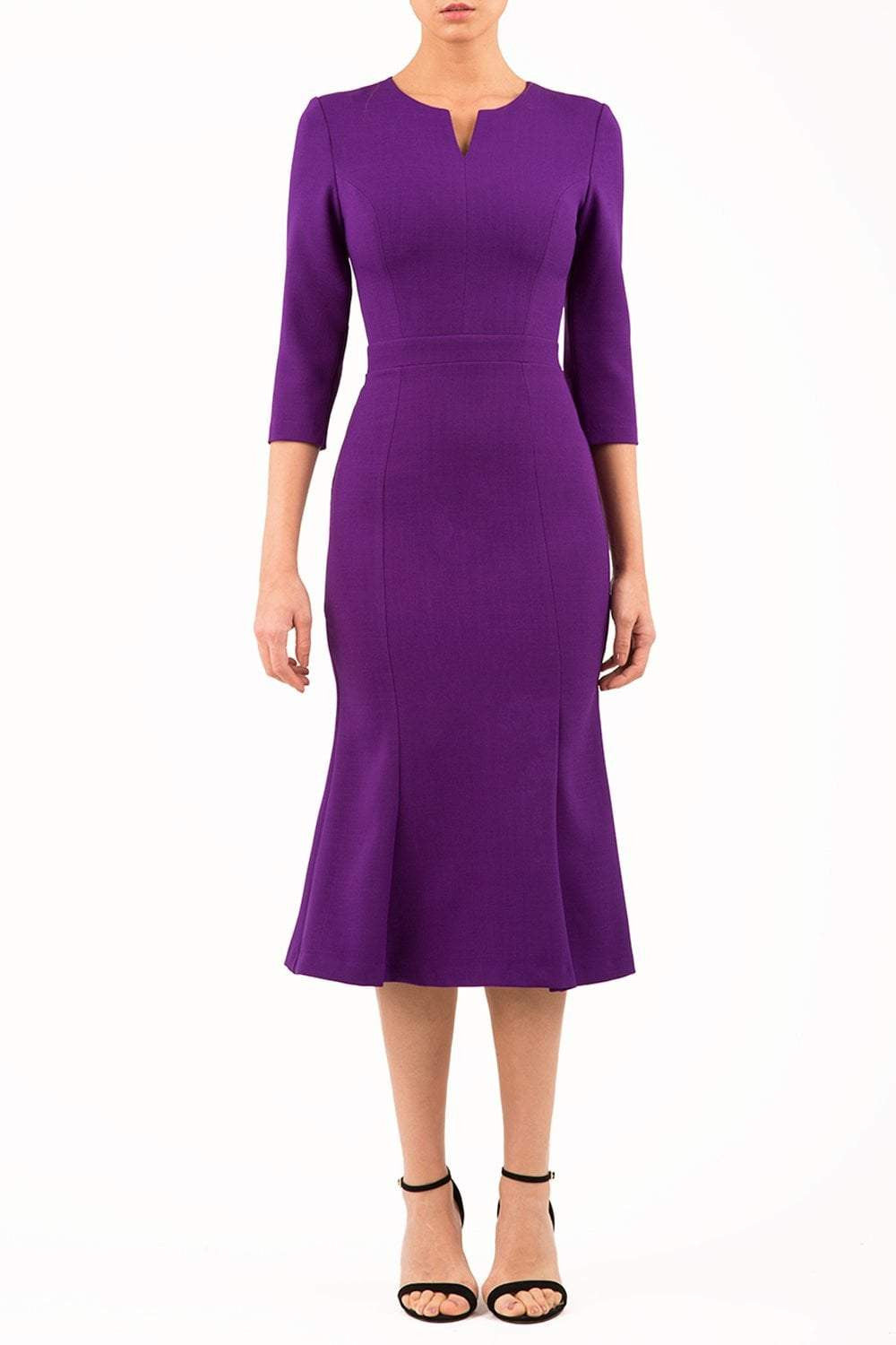 blonde model is wearing diva catwalk senne midaxi sleeved dress with fishtail and rounded neckline with a slit in the middle in purple front