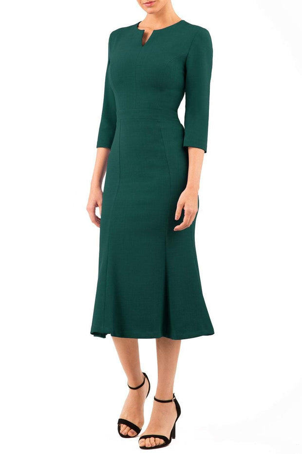 blonde model is wearing diva catwalk senne midaxi sleeved dress with fishtail and rounded neckline with a slit in the middle in forest green front