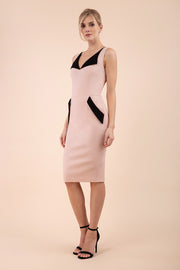 blonde model wearing diva catwalk chevy wiggle pencil dress without sleeves with side pocket detail and lowered v-neckline in nude pink front