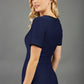 blonde model wearing seed albany contrasted pencil-skirt dress with short sleeves and pleating across the tummy with low square neckline and contrasted detail finishing in navy blue back