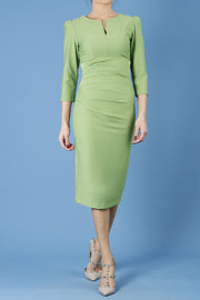 model is wearing diva catwalk seed fitzrovia sleeved pencil dress in citrus green front