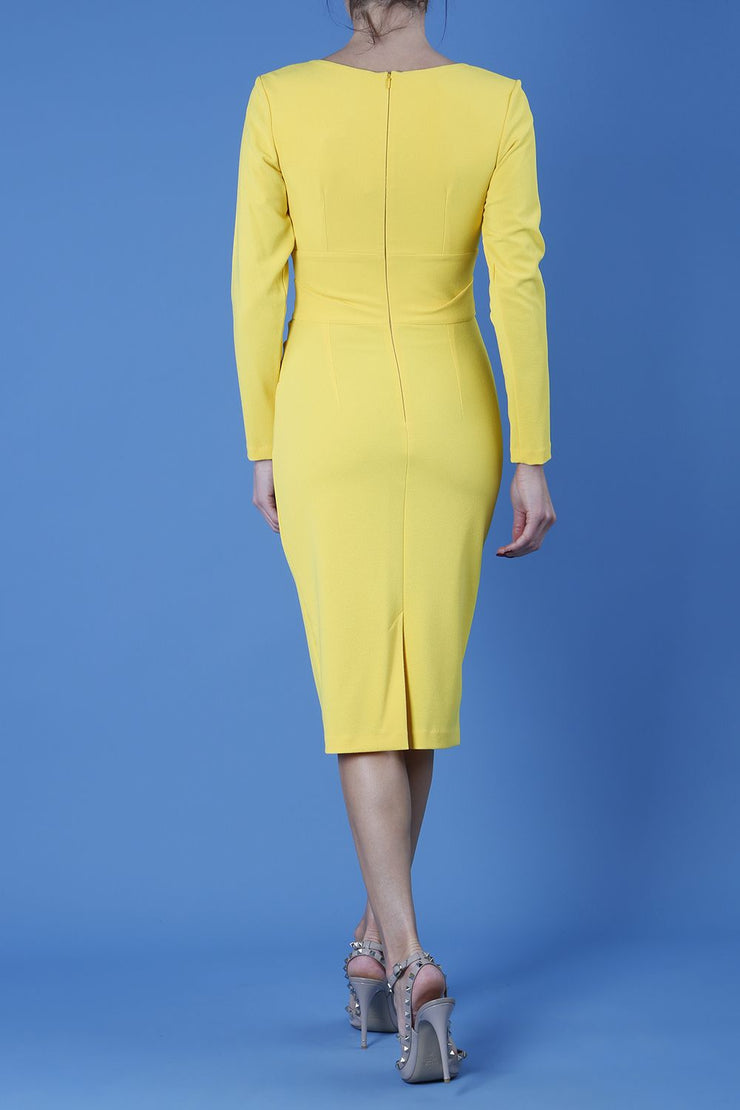 model is wearing diva catwalk cynthia long sleeve pencil dress with low v-neckline in freesia yellow back