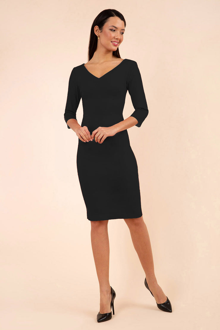 brunette model wearing diva catwalk natalie pencil-skirt dress with sleeves and v-neckline in black front
