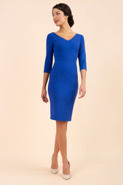 brunette model wearing diva catwalk natalie pencil-skirt dress with sleeves and v-neckline in royal blue front