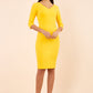 brunette model wearing diva catwalk natalie pencil-skirt dress with sleeves and v-neckline in yellow front