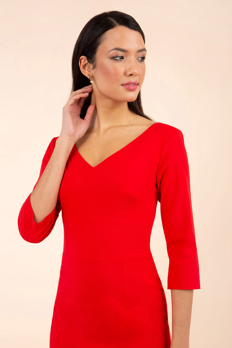 brunette model wearing diva catwalk natalie pencil-skirt dress with sleeves and v-neckline in red front