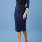 model is wearing diva catwalk stamford pencil dress with low v-neck and wide contrasting band in circle cobalt blue front