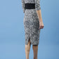 model is wearing diva catwalk stamford pencil dress with low v-neck and wide contrasting band in circle grey back