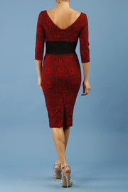 model is wearing diva catwalk stamford pencil dress with low v-neck and wide contrasting band in circle red back