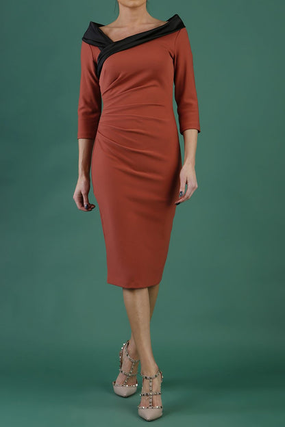 model is wearing diva catwalk pencil dress with contrasting asymmetric satin neckline in marsala brown front