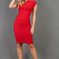 model wearing diva catwalk daphne sleeveless pencil skirt dress with rounded neckline with split in the middle in electric red colour sheath dress front