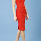 model wearing diva catwalk daphne sleeveless burn orange pencil dress with rounded neckline with split in the middle in front side