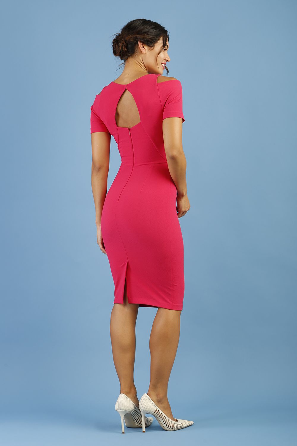 model wearing diva catwalk ruth pencil skirt dress with a keyhole cut in rounded neckline and cold shoulder detail in honeysuckle pink colour back