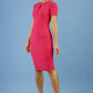model wearing diva catwalk ruth pencil skirt dress with a keyhole cut in rounded neckline and cold shoulder detail in honeysuckle pink colour front