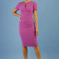 model wearing diva catwalk ruth pencil skirt dress with a keyhole cut in rounded neckline and cold shoulder detail in orchid purple colour front