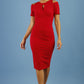 model wearing diva catwalk ruth pencil skirt dress with a keyhole cut in rounded neckline and cold shoulder detail in scarlet red colour front