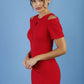 model wearing diva catwalk ruth pencil skirt dress with a keyhole cut in rounded neckline and cold shoulder detail in scarlet red colour front