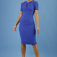 model wearing diva catwalk ruth pencil skirt dress with a keyhole cut in rounded neckline and cold shoulder detail in riviera blue colour front