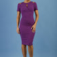 model wearing diva catwalk ruth pencil skirt dress with a keyhole cut in rounded neckline and cold shoulder detail in royal purple colour front