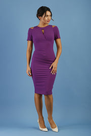 model wearing diva catwalk ruth pencil skirt dress with a keyhole cut in rounded neckline and cold shoulder detail in royal purple colour front