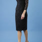 model is wearing diva catwalk bucklebury lace dress with sleeved and low neckline in black front