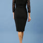 model is wearing diva catwalk bucklebury lace dress with sleeved and low neckline in black back