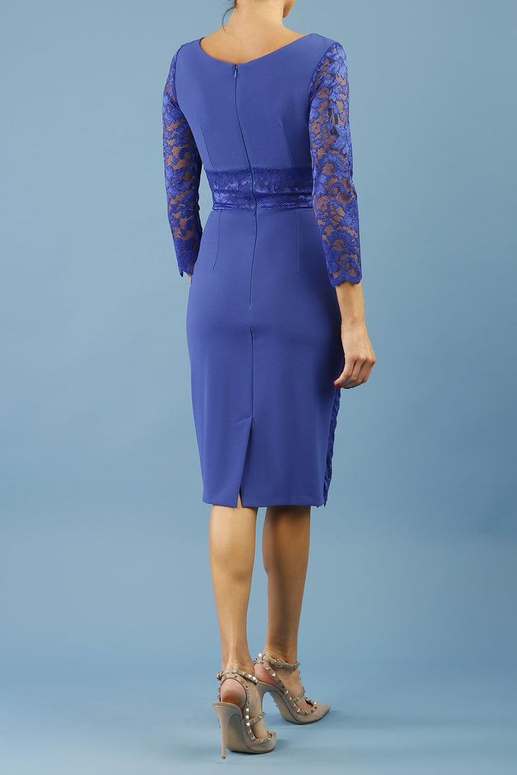 model is wearing diva catwalk bucklebury lace dress with sleeved and low neckline in riviera blue back