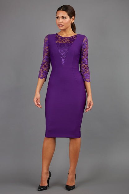 Brunetter Model is wearing seed couture lace pencil dress by diva catwalk in purple front