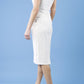 model is wearing diva catwalk seed cadiz pencil sleeveless dress in sandy cream side