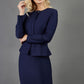 blonde model is wearing seed diva dawlish navy pencil skirt paired with jacket in navy front