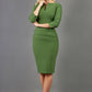 Model wearing the Diva Daphne ¾ Sleeved dress with pleat detail across the hips and ¾ sleeve length in vineyard green front