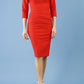 Model wearing Diva catwalk Daphne ¾ Sleeved pencil-skirt dress with pleat detail across the hips and ¾ sleeve length in burnt orange front