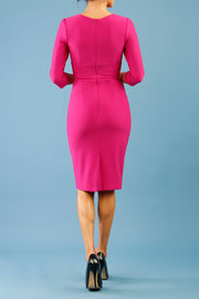 Model wearing the Diva Daphne ¾ Sleeved dress with pleat detail across the hips and ¾ sleeve length in magenta haze back