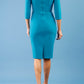 Model wearing the Diva Daphne ¾ Sleeved dress with pleat detail across the hips and ¾ sleeve length in mosaic blue back