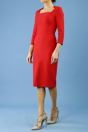 model is wearing seed rowena pencil dress with sleeves and square neckline in salsa red front