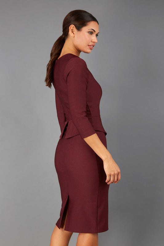 Brunette Model is wearing a three quarter sleeve couture seed pencil dress frill side detail by Diva Catwalk