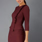 Brunette Model is wearing a three quarter sleeve couture seed pencil dress frill side detail by Diva Catwalk