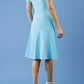 model is wearing diva catwalk madison a-line dress with square neckline and short sleeve in celestial blue back