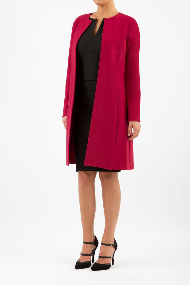 model wearing diva catwalk beet red coat with long sleeves and a belt front
